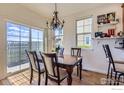 Bright dining room with hardwood floors, a chandelier, and sliding glass doors to the backyard at 3752 Red Deer Trl, Broomfield, CO 80020
