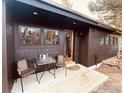 Charming home with a patio, dark wood siding, trimmed windows, and an outdoor seating area at 501 Main St, Boulder, CO 80302