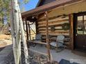 Cozy front porch with chairs, rustic log columns, and charming decor at 501 Main St, Boulder, CO 80302