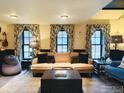 Comfortable living room with a couch, beanbag, curtains and three bright windows at 501 Main St, Boulder, CO 80302