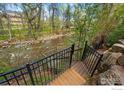 Scenic backyard view of a river from a wooden staircase at 563 Arapahoe Ave, Boulder, CO 80302