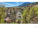 Beautiful two story home surrounded by trees and landscaping with a mountain view at 563 Arapahoe Ave, Boulder, CO 80302