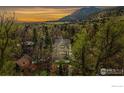 Charming two-story home nestled in a lush landscape, with mountain views at sunset at 563 Arapahoe Ave, Boulder, CO 80302