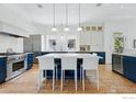 Spacious kitchen featuring an island with seating, stainless steel appliances, and ample cabinetry at 563 Arapahoe Ave, Boulder, CO 80302