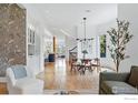 Open-concept living area with hardwood floors, modern decor, and abundant natural light at 563 Arapahoe Ave, Boulder, CO 80302