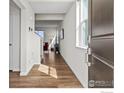 Inviting entryway with hardwood floors leading into a bright, modern living space at 5881 Red Barn Ave, Mead, CO 80504