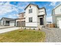 Attractive two-story home with a front yard featuring rocks and fresh sod at 5881 Red Barn Ave, Mead, CO 80504