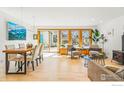 Bright living room with hardwood floors, dining area, and large windows with natural light and outdoor views at 644 Dewey Ave, Boulder, CO 80304