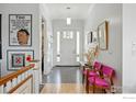 Inviting entryway featuring patterned tile flooring, bright white walls, and stylish furnishings at 7531 Spring Dr, Boulder, CO 80303