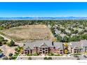 This aerial showcases the condo's neighborhood, set against a backdrop of majestic mountains and open space at 804 Summer Hawk Dr # 8105, Longmont, CO 80504