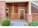 The inviting entrance displays brick accents, unit numbers, and convenient access to the fire riser room at 804 Summer Hawk Dr # 8105, Longmont, CO 80504