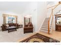 Bright living room with vaulted ceiling, plush carpeting, and comfortable seating at 9506 Yukon St, Westminster, CO 80021