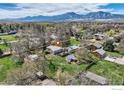 Stunning aerial view of a property with mountain views and mature landscaping at 1098 Cherryvale Rd, Boulder, CO 80303