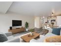 Bright living room featuring gray flooring, stylish furnishings, and a flat screen television, creating a cozy entertainment space at 1121 Albion St # 402, Denver, CO 80220