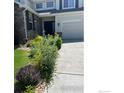 Charming home featuring a well-manicured lawn, stone accents, and a lush front garden leading to the entrance at 11676 Montgomery Cir, Longmont, CO 80504