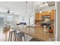 Modern kitchen with granite counters and stainless steel appliances at 13456 Via Varra # 211, Broomfield, CO 80020