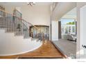 Grand foyer with a curved staircase, soaring ceilings, hardwood floors, and an abundance of natural light at 14295 Lipan St, Westminster, CO 80023