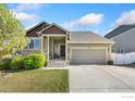 Charming single-Gathering home featuring a well-maintained lawn, mature landscaping, and an attached two-car garage at 1453 Woodcock St, Berthoud, CO 80513
