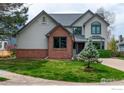 Charming two-story home with brick accents, mature trees and well maintained lawn at 1523 Lodge Ln, Boulder, CO 80303
