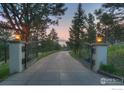 Private gated entrance with a long driveway leading to the estate at 1530 Timber Ln, Boulder, CO 80304