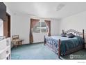 Bright bedroom with a comfortable bed, patterned curtains, and serene atmosphere at 18030 E Loyola Dr, Aurora, CO 80013