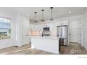 Spacious kitchen featuring a large island, stainless steel appliances, and ample counter space at 193 Liberty St, Erie, CO 80516
