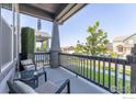 Inviting front porch with comfortable seating, perfect for relaxing and enjoying the neighborhood views at 21574 E 59Th Dr, Aurora, CO 80019