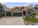 Charming brick home with a three-car garage and professional landscaping offers great curb appeal at 2190 Coyote Creek Dr, Fort Lupton, CO 80621