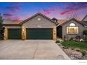 Charming brick home with a three-car garage and well-manicured lawn, featuring professional landscaping and mature plantings at 2190 Coyote Creek Dr, Fort Lupton, CO 80621