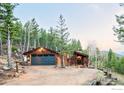 Charming mountain cabin with a two-car garage nestled among lush green trees at 279 Forrest Ln, Boulder, CO 80302