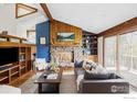 Cozy living room with stone fireplace, wood accents, and comfortable seating arrangement at 279 Forrest Ln, Boulder, CO 80302