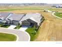 Beautiful home with a well-manicured lawn and an attached two car garage at 3304 Heron Lakes Pkwy, Berthoud, CO 80513