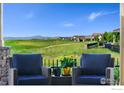 Inviting patio seating area with beautiful views of the surrounding landscape and neighborhood at 3304 Heron Lakes Pkwy, Berthoud, CO 80513