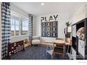 Bright bedroom with a large window, stylish decor, a playful atmosphere and a comfortable study space at 368 Chardon Ave, Brighton, CO 80601