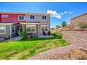 Relax in this cozy backyard featuring a well-manicured lawn and privacy with a retaining wall at 4027 E 98Th Pl, Thornton, CO 80229