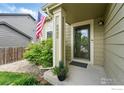 Welcoming front porch featuring house number, patriotic American flag, and fresh landscaping at 4774 Coker Ave, Castle Rock, CO 80104