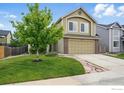 Inviting two-story home featuring a lush front yard and attached two-car garage at 4774 Coker Ave, Castle Rock, CO 80104