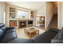 Cozy living room featuring a fireplace with built-in shelving and open layout to the dining area at 4774 Coker Ave, Castle Rock, CO 80104