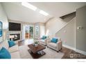 Bright living room featuring a fireplace, plush seating, and sliding glass doors to the exterior at 5146 Buckingham Rd, Boulder, CO 80301