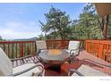 Relax on this deck with an outdoor fireplace while overlooking the surrounding nature at 524 Cutter Ln, Boulder, CO 80302