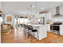 Modern kitchen with a large island, pendant lighting, stainless steel appliances, and open floor plan at 6163 Easton Cir, Frederick, CO 80504