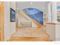 Inviting foyer with tile flooring, wood trim, staircase, and view to the home interior at 787 Niwot Ridge Ln, Lafayette, CO 80026