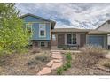 Charming home with a manicured front yard and stone walkway at 1011 Glenwood Dr, Lafayette, CO 80026