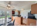 Eat-in kitchen featuring an island, wood cabinets and access to outdoor deck at 1011 Glenwood Dr, Lafayette, CO 80026