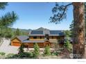 Beautiful two-story home with solar panels and a lush landscape at 1472 Timber Ln, Boulder, CO 80304