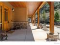 Inviting covered porch with stone accents and wooden beams at 1472 Timber Ln, Boulder, CO 80304