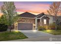 Charming single-Gathering home featuring a stone facade, neutral color palette, and a spacious two-car garage at 1511 Bowen St, Longmont, CO 80501