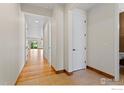 Bright hallway with hardwood and tile flooring leading to the rest of the home at 1511 Bowen St, Longmont, CO 80501