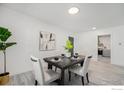 Well-lit dining area with a dark wood table, seating for four, and modern decor at 1580 S Krameria St, Denver, CO 80224