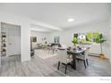 Bright, open living and dining area with neutral tones and wood-look floors creates a welcoming space at 1580 S Krameria St, Denver, CO 80224